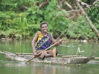 Woman on a small boat in Papua New Guinea