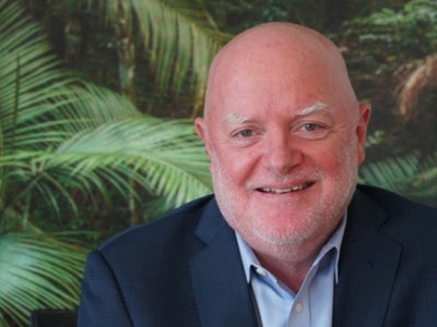 Portrait of a man with plants in background