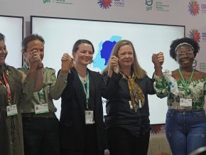 Women holding hands after a panel discussion