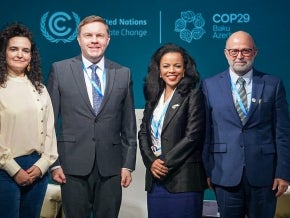 Four people standing on stage at an event