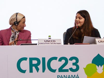 Two women speaking on a panel